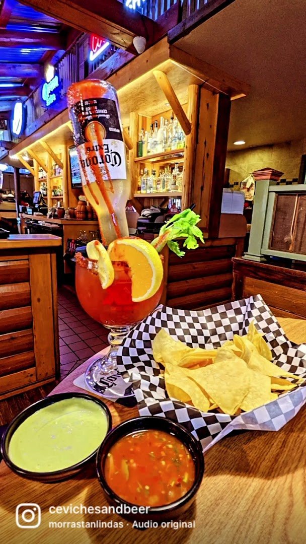 Colorful plates beside drinks and salsa.